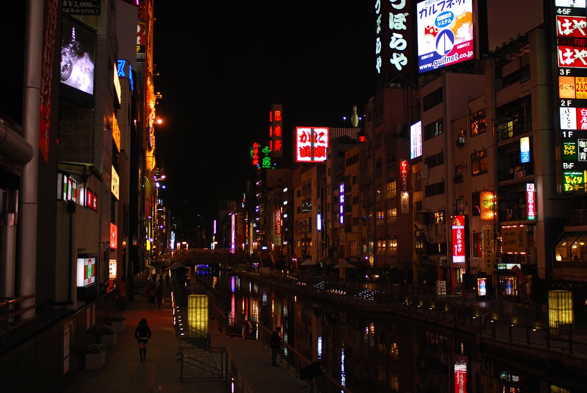 Dotonbori canal at night, neon signage reflected on the water